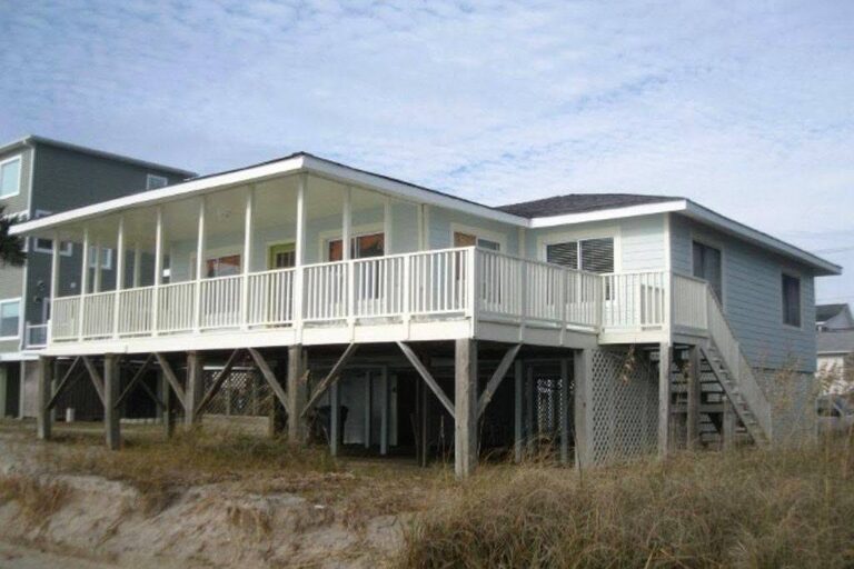Classic raised Edisto Beach cottage with a wraparound porch