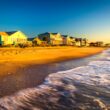 Oceanfront beach houses along Edisto Beach at sunset